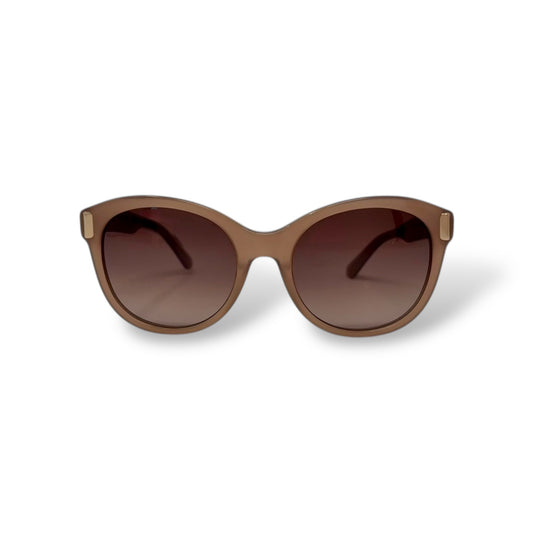 Brown sunglasses with a gradient lens on a white background