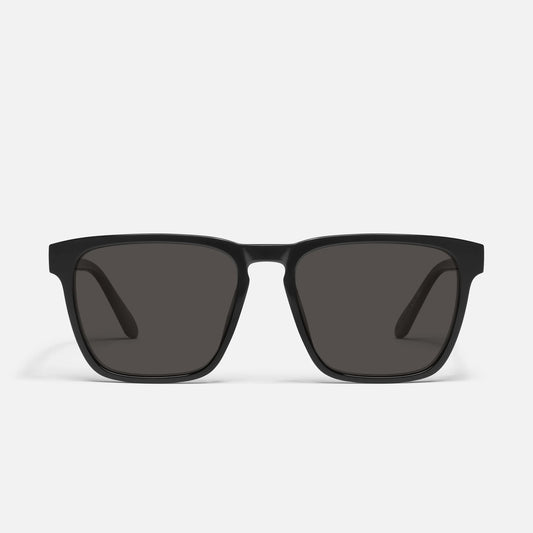 Black sunglasses with dark lenses on a white background