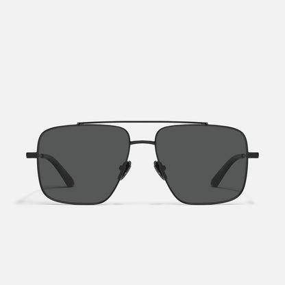 Sunglasses with dark lenses on a light gray background