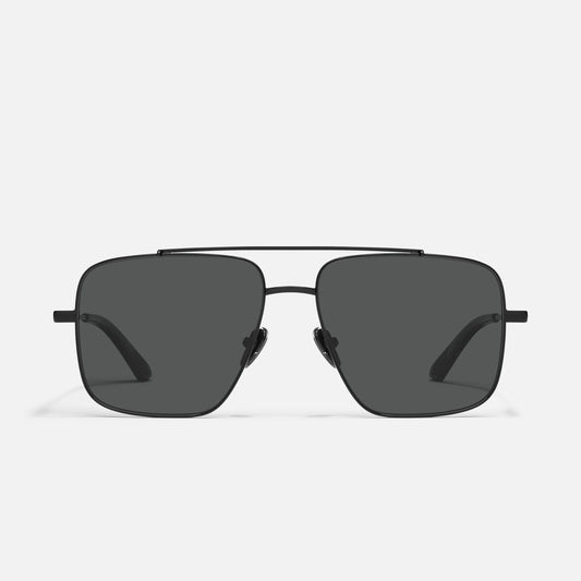 Sunglasses with dark lenses on a light gray background