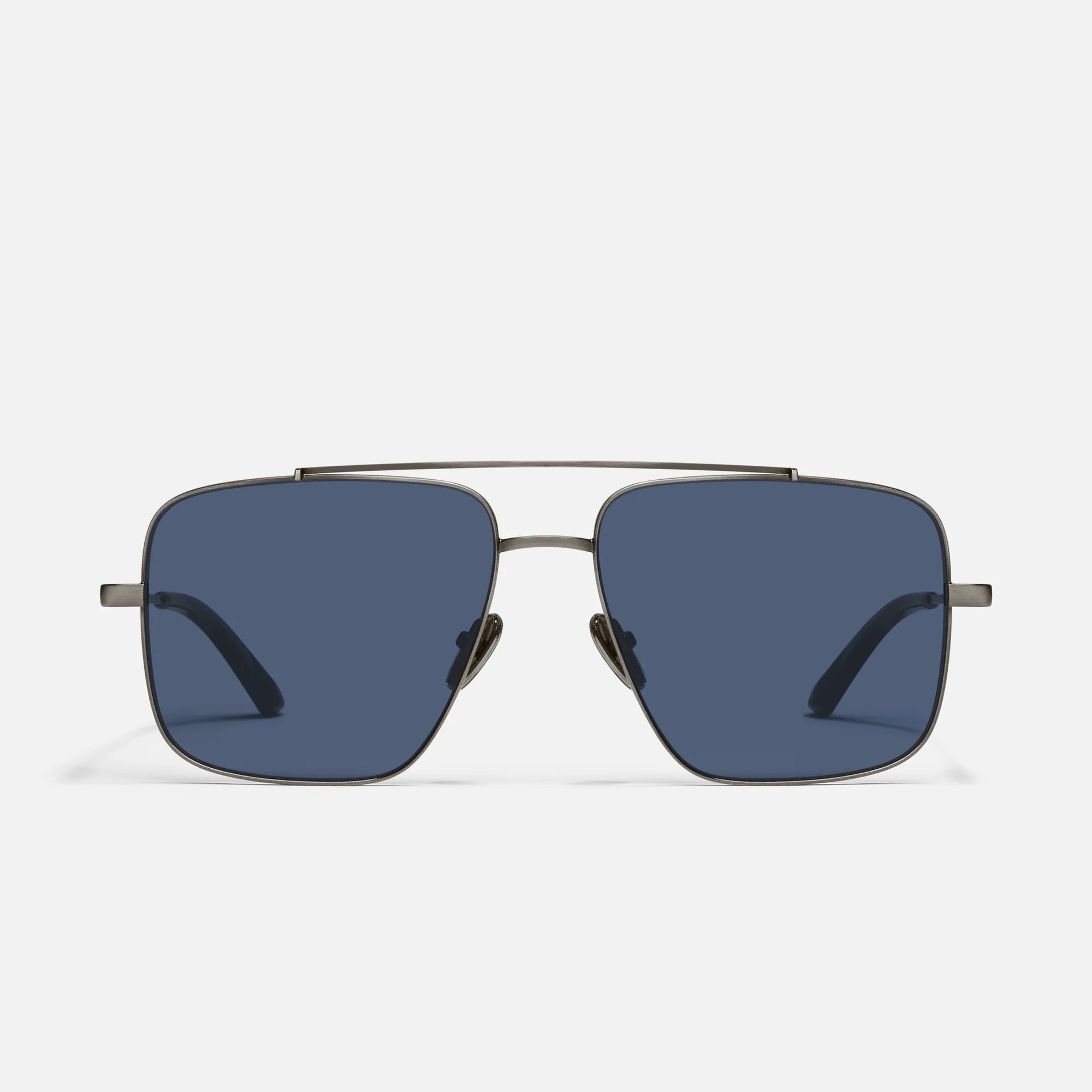 Sunglasses with a gold frame and blue lenses on a white background