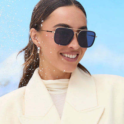 Woman wearing sunglasses with a clear blue sky background