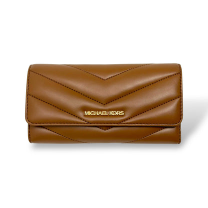 Michael Kors Cognac colored trifold wallet with gold toned logo. Picture features a front facing picture of the closed wallet