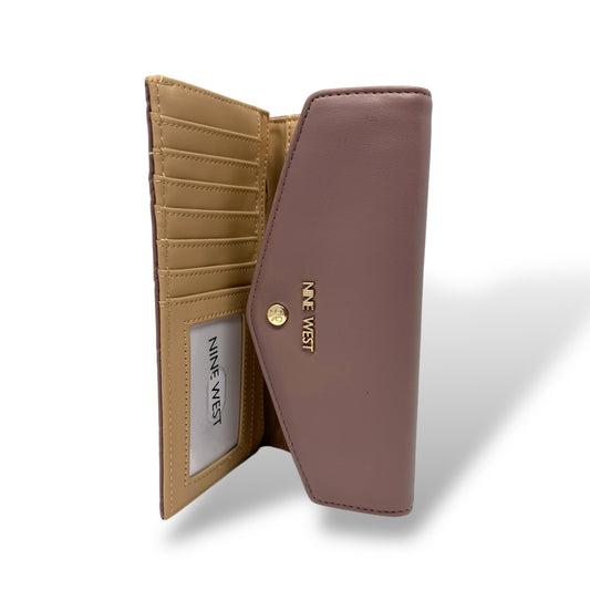 Nine West women’s trifold wallet. Rose quartz color with gold toned logo and snap button. Picture featuring the interior of the wallet with the logo