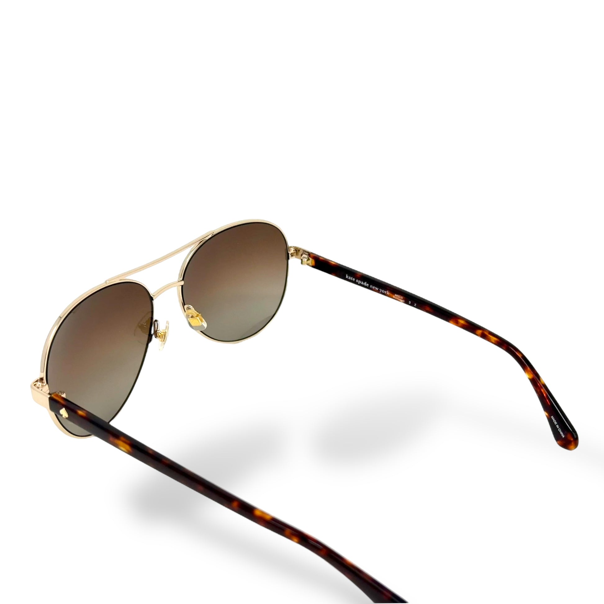 Sunglasses with tortoiseshell frame and brown lenses on a white 
background
Kate Spade - Averie/S
Frame style: aviator
Frame Color: gold-tone wire frame with brown tortoise color arms
Lens Color: brown gradient