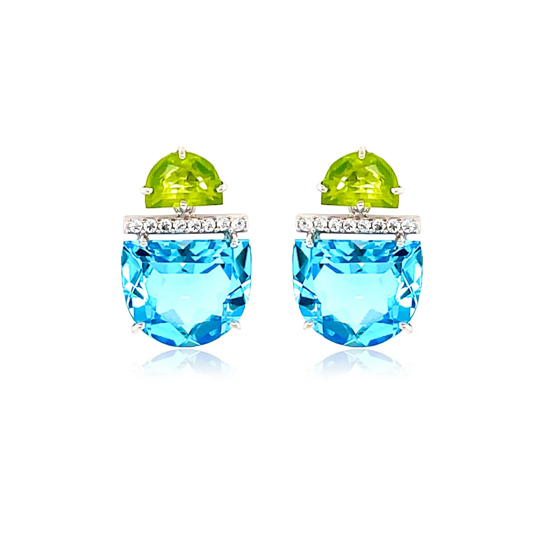Pair of earrings with blue gemstones and green tops on a white background
Rhodium plated over 925 Silver - 2.5 grs
Half moon cut Sky Blue Topaz, Peridot&nbsp;- 10.6 cts
16 White Topaz round 1.0 mm diamond cut