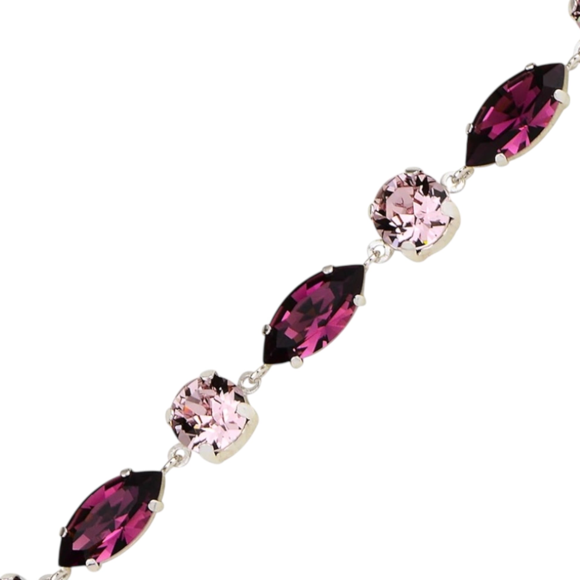Bracelet with pink and purple gemstones on a white background
Material: 925 sterling silver, Rhodium plated, purple and light rose Swarovski crystals&nbsp;

Color: silver, purple, and light rose

Measurement: 6" length, 1" extension, 6 mm wide&nbsp;