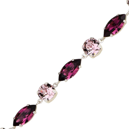 Bracelet with pink and purple gemstones on a white background
Material: 925 sterling silver, Rhodium plated, purple and light rose Swarovski crystals&nbsp;

Color: silver, purple, and light rose

Measurement: 6" length, 1" extension, 6 mm wide&nbsp;