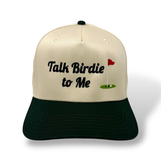 Beige and black cap with 'Talk Birdie to Me' text and golf flag design on a white background
Color: tan and dark green two-toned hat

Style: 5 panel structured fabric trucker hat

Closure: snapback adjustable sizing

Material: 65% polyester, 35% cotton