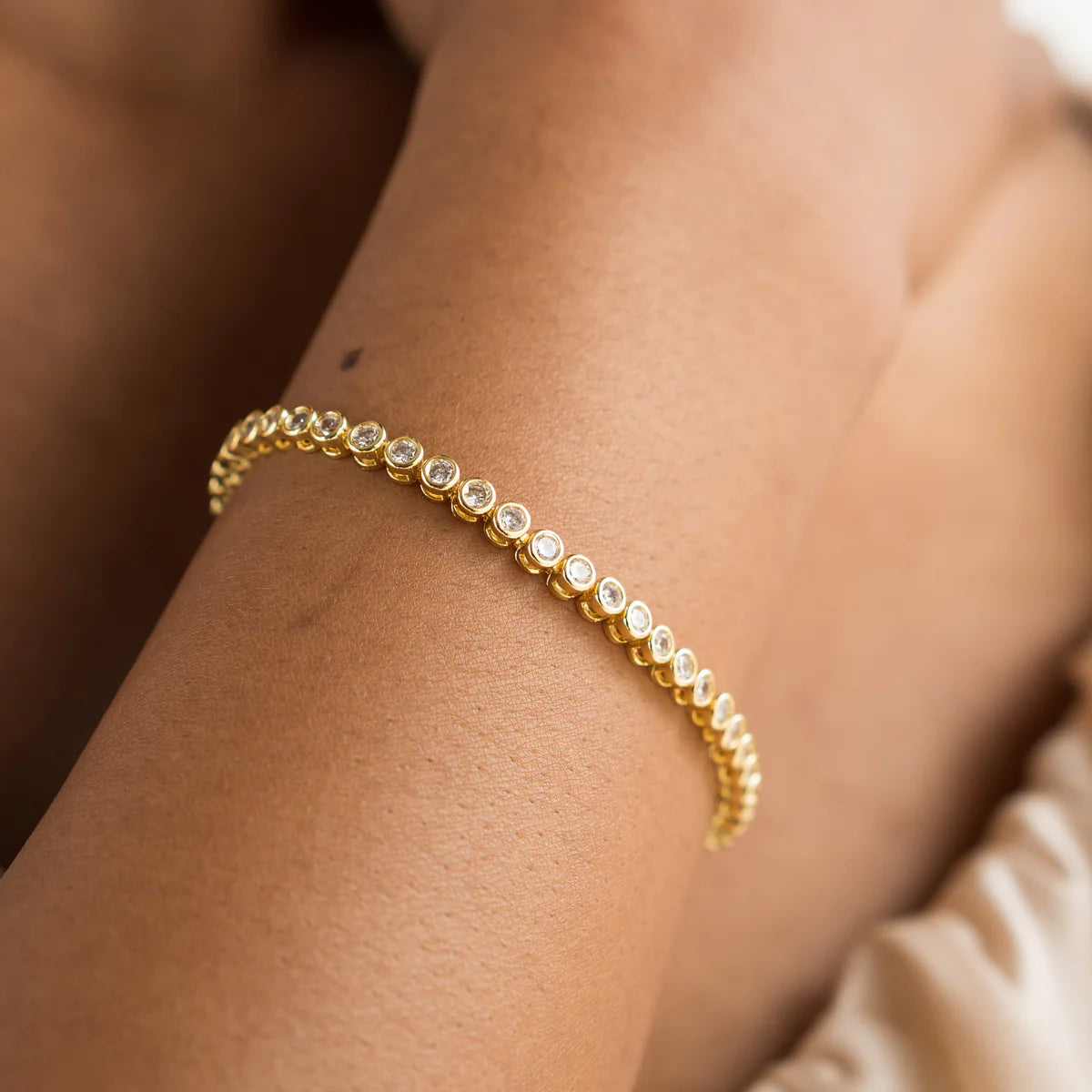 Gold bracelet with small diamonds on a wrist