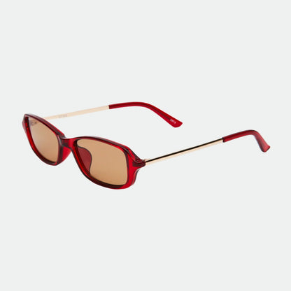 Red sunglasses with gold accents on a white background