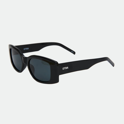 Black sunglasses with 'OTRA' branding on a white background