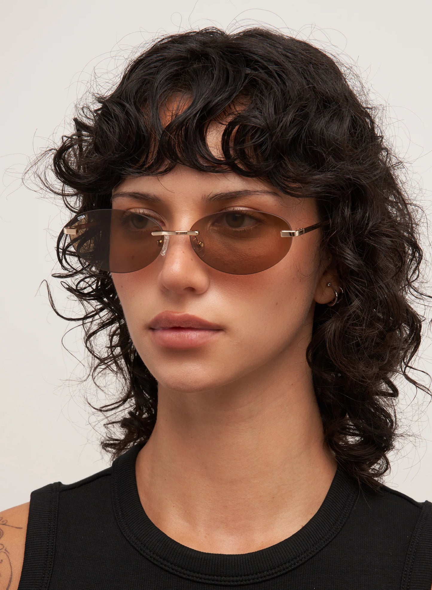 Person wearing sunglasses with a neutral background