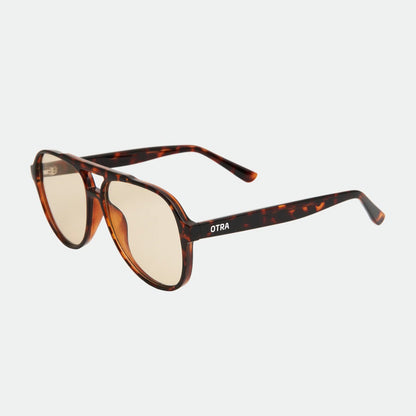 Sunglasses with tortoiseshell frame and brown lenses on a light gray background