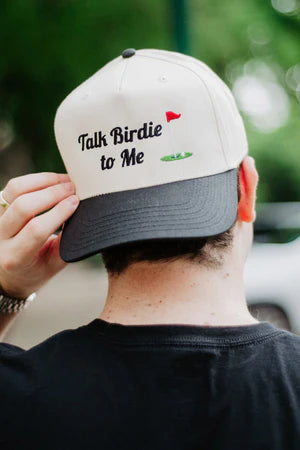 Person wearing a cap with 'Talk Birdie to Me' text and a heart symbol.