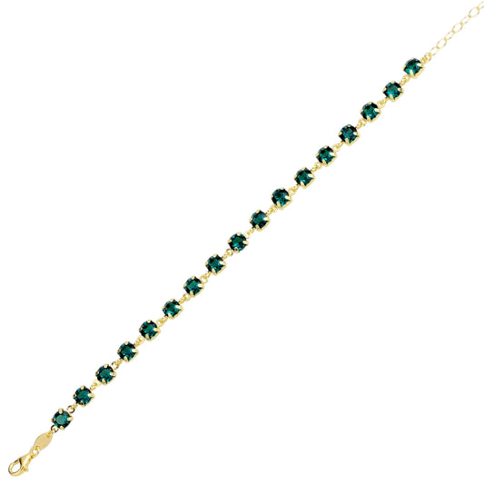 Gold bracelet with green swarovski crystals on a white background