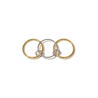 Three interlocking rings in gold, silver, and rose gold on a white background