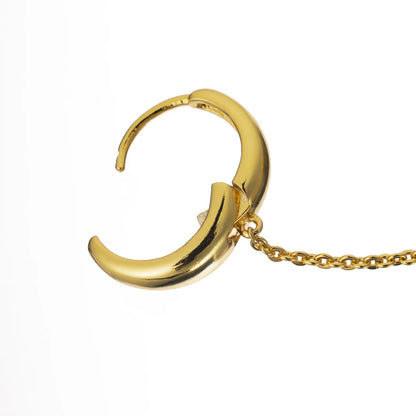 Gold hoop earring with a chain on a white background