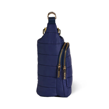 Navy blue sling bag with gold zippers on a white background