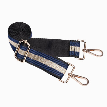 Black and blue striped bag strap with gold hardware on a white background