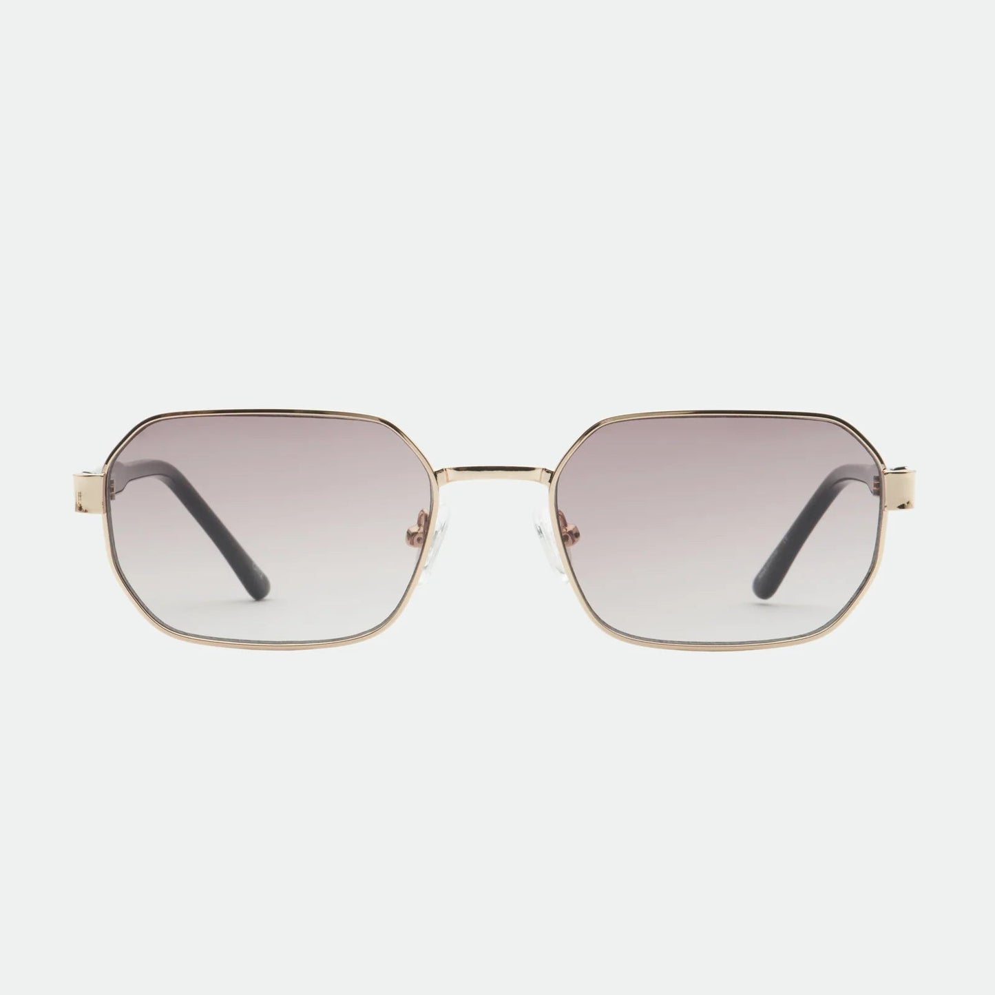 Sunglasses with gold frame and gradient lenses on a white background