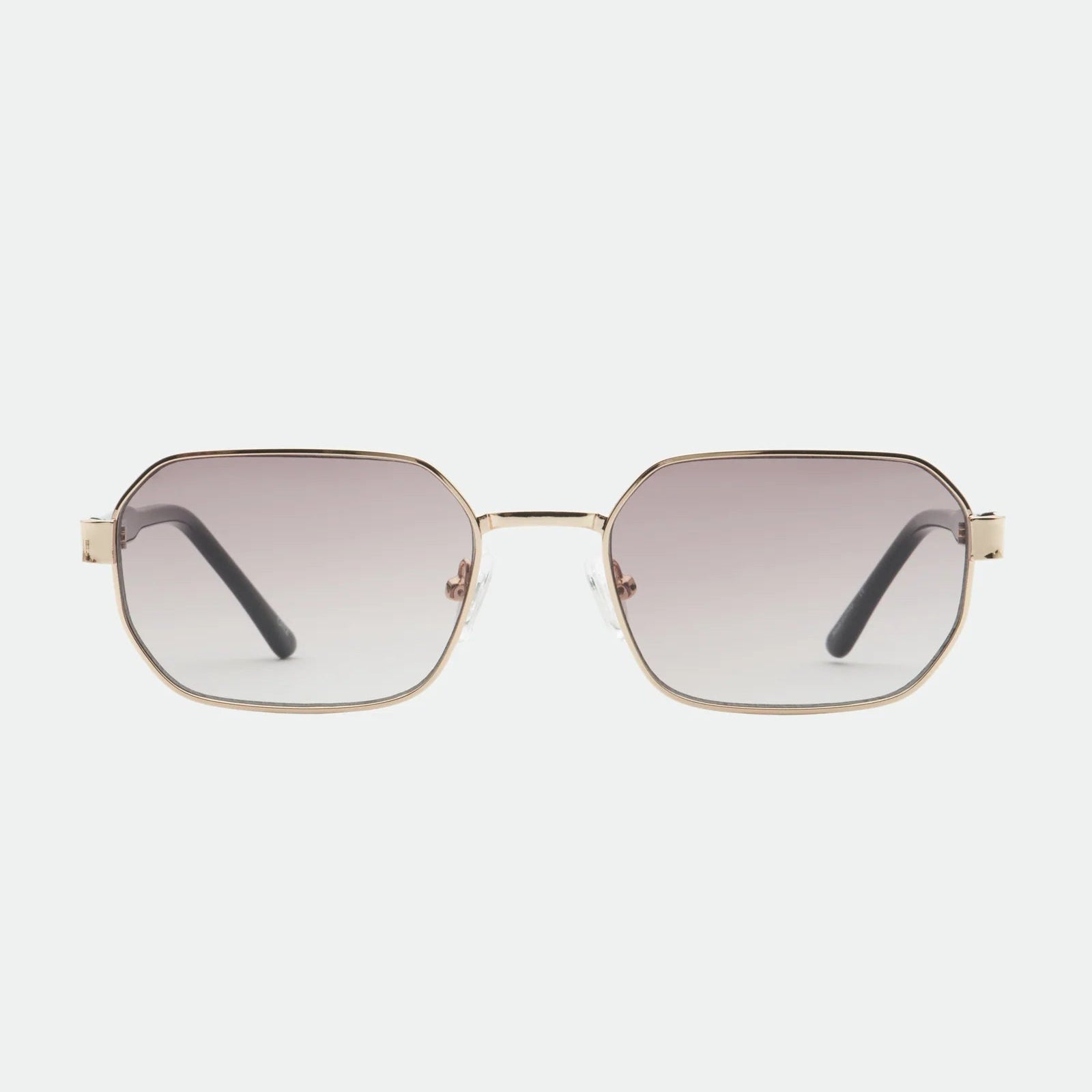Sunglasses with gold frame and gradient lenses on a white background