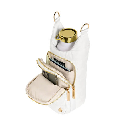 White handbag with gold accents containing a phone, card, and small round item on a white background