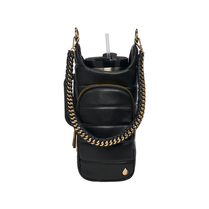 Black leather bag with gold chain strap and cup holder on a white background