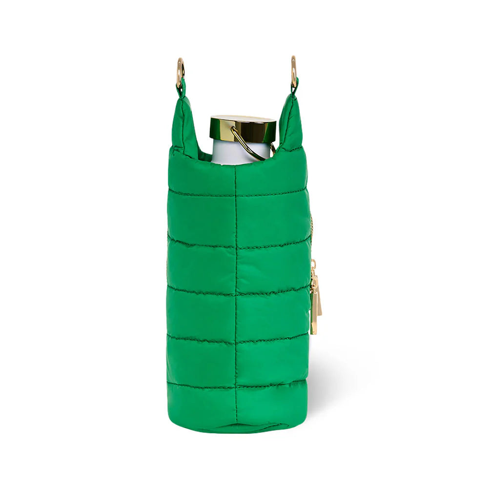 Green quilted bag with gold accents on a white background