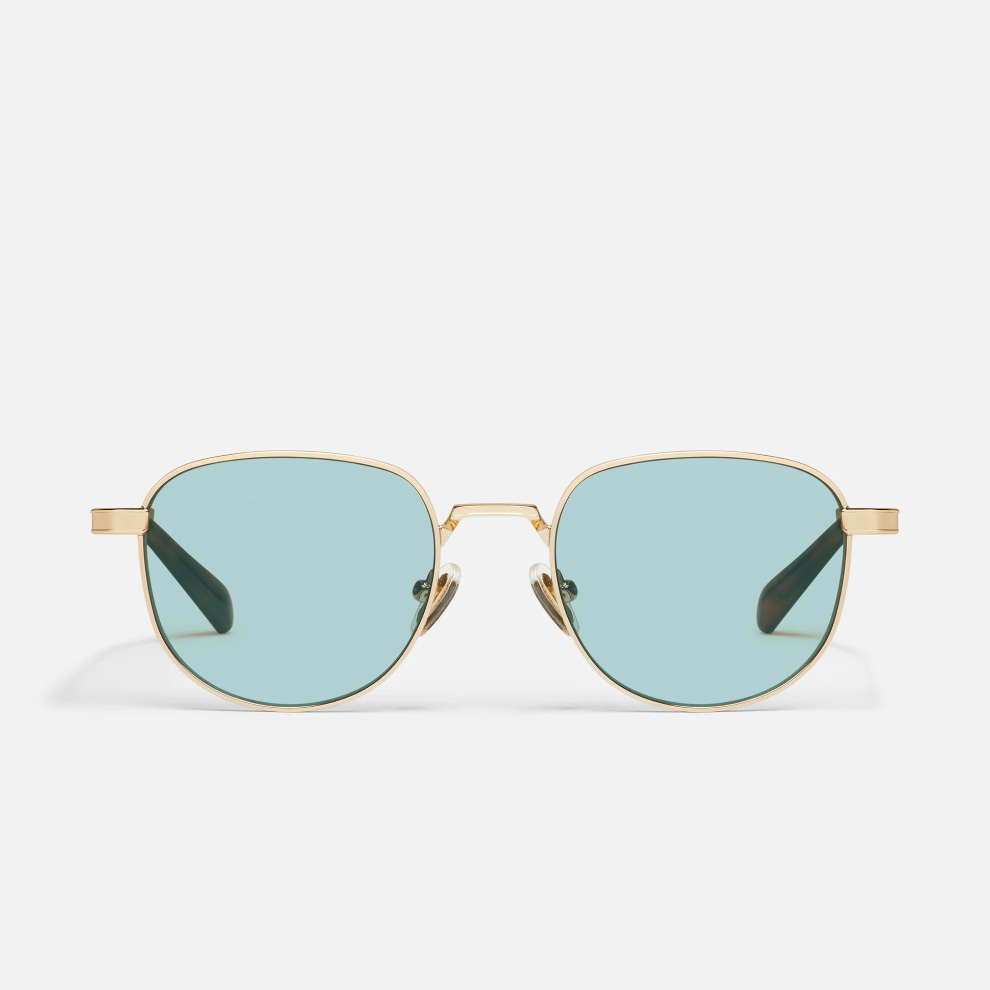 Gold-framed sunglasses with light blue lenses on a white background