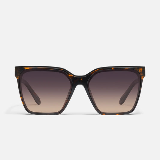 Sunglasses with tortoiseshell frame and gradient lenses on a white background