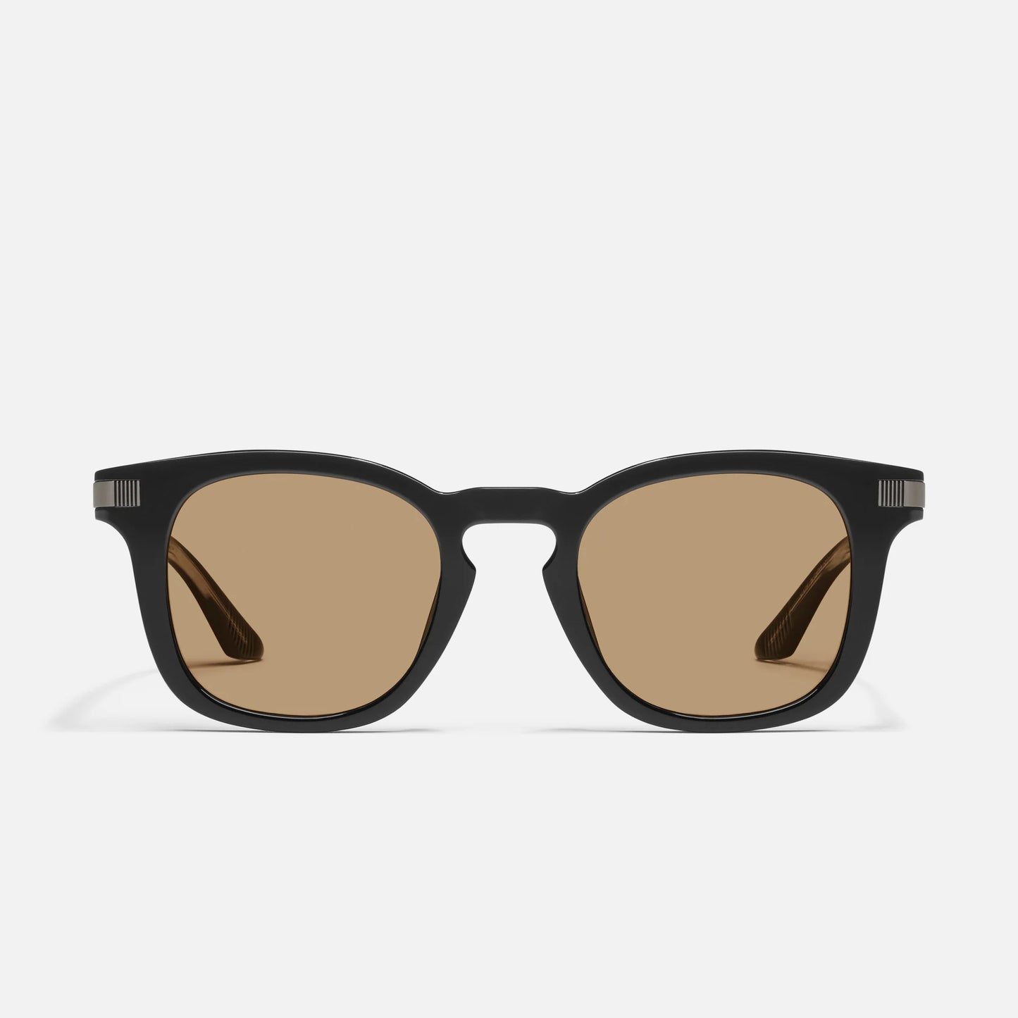 Black sunglasses with brown lenses on a white background