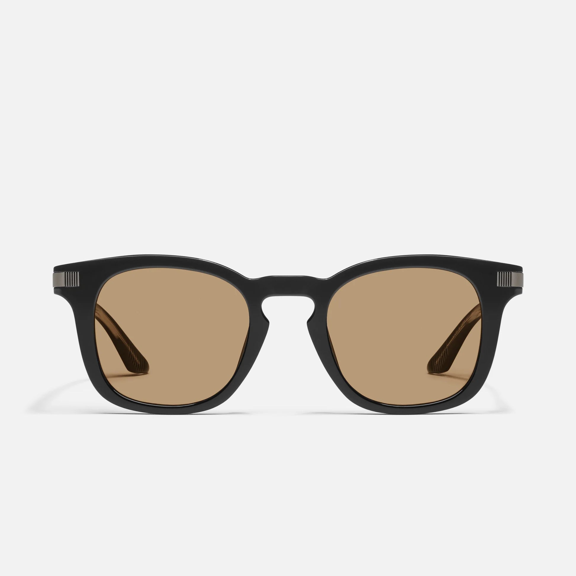 Black sunglasses with brown lenses on a white background