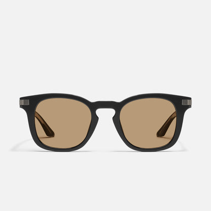 Black sunglasses with brown lenses on a white background