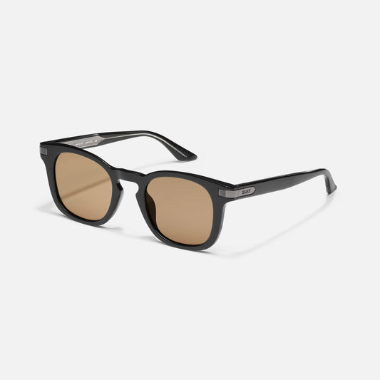 Black sunglasses with brown lenses on a white background
