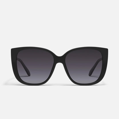 Black sunglasses with dark lenses on a light gray background