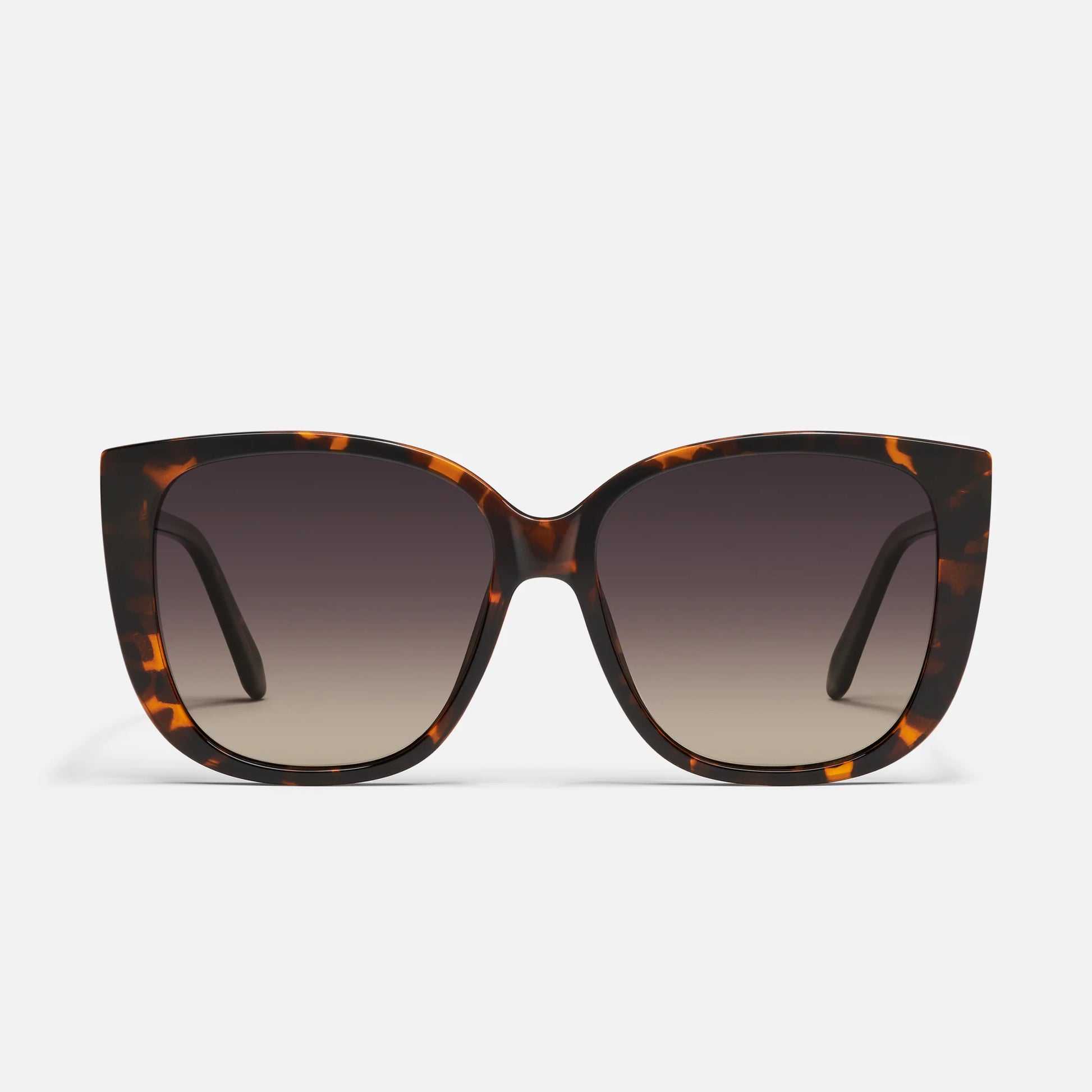 Sunglasses with tortoiseshell frame and gradient lenses on a white background