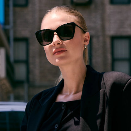 Woman wearing black sunglasses and a black outfit outdoors