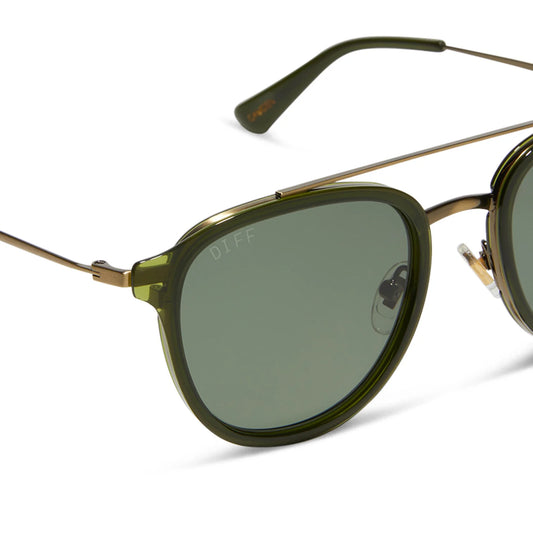 Green sunglasses with gold frames on a white background