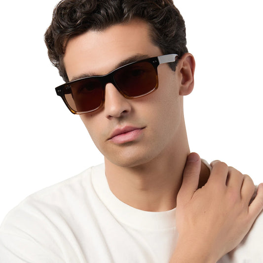 Man wearing sunglasses with a neutral background
