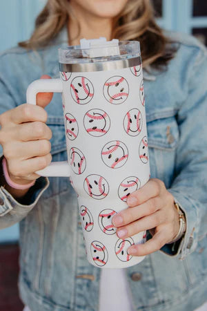 Person holding a mug with baseball-themed design