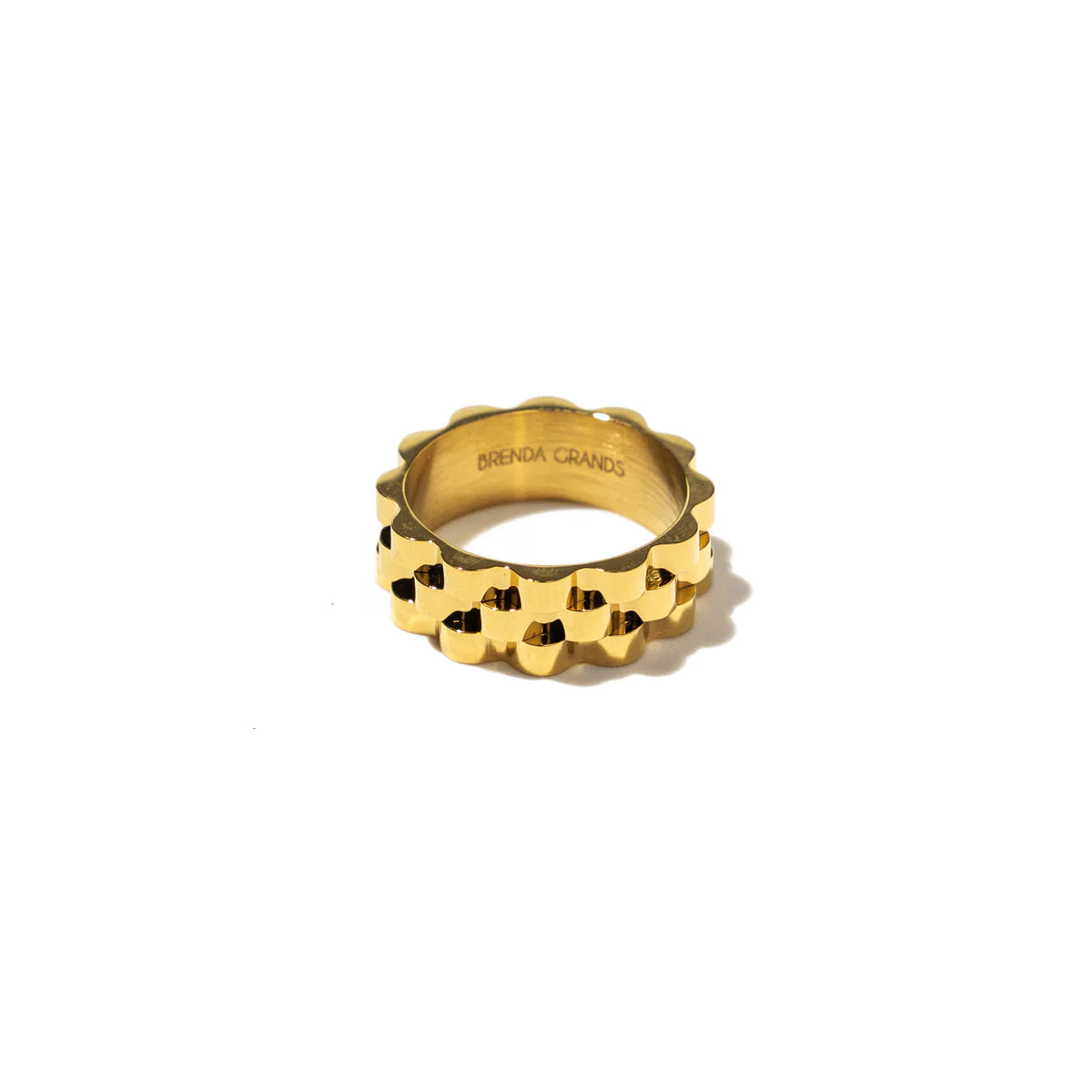 Gold ring with a unique design on a white background