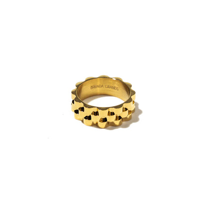 Gold ring with a unique design on a white background