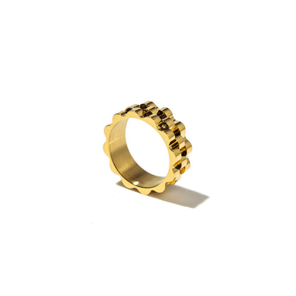 Gold ring with a textured band on a white background