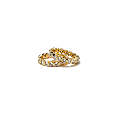 Gold ring with embedded stones on a white background