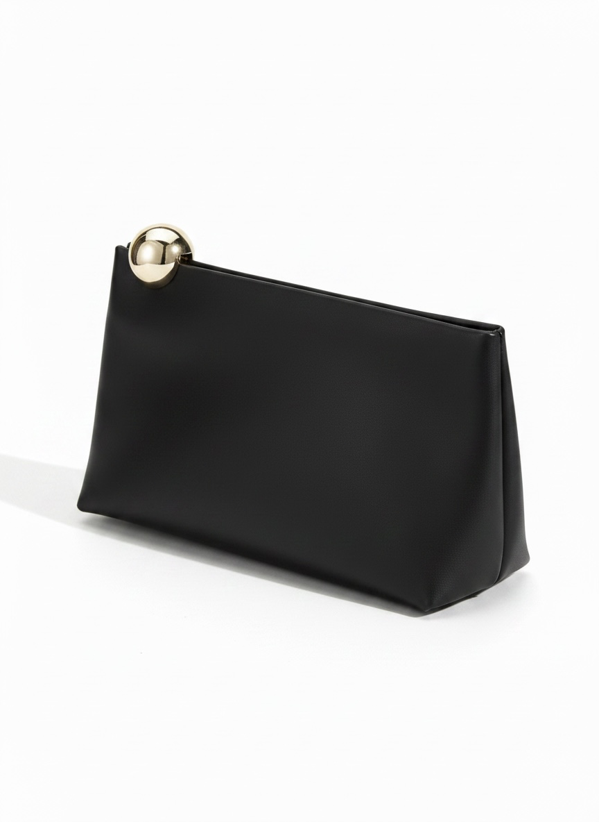 A black faux leather clutch bag with a gold-tone metal sphere accent on the zipper pull, shown on a clean white background.