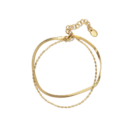 Two gold anklet stacked on a white background