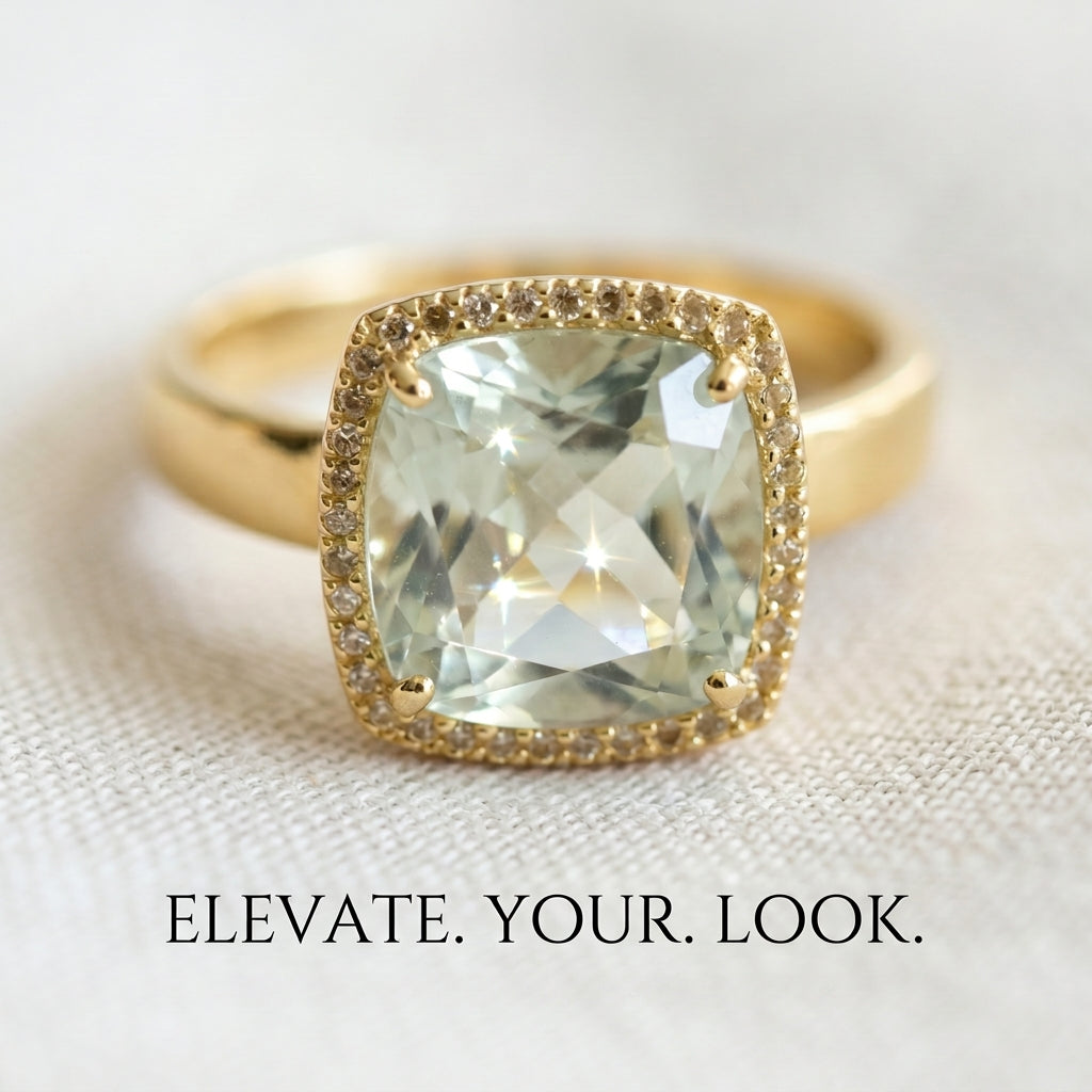 Gold ring with a large green gemstone on a light fabric background, with text 'Elevate. Your. Look.'