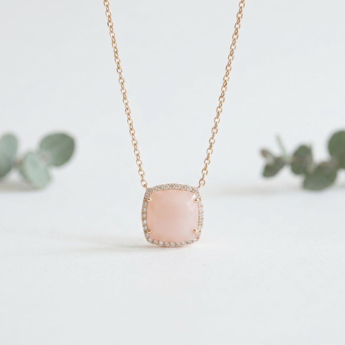 Necklace with a pink pendant on a light background