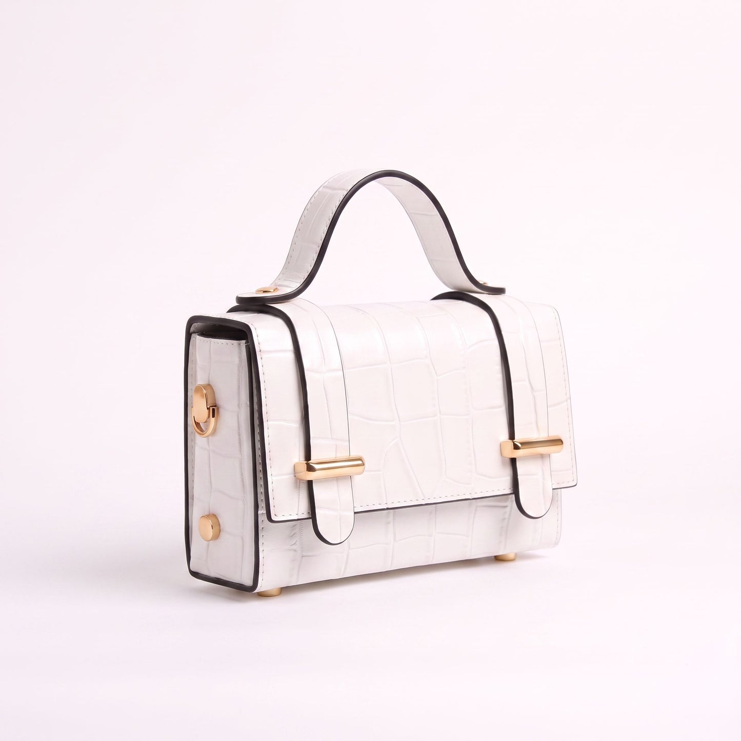 A structured white crocodile-embossed handbag with black trim, gold-tone hardware, and a top handle, photographed on a clean white background.